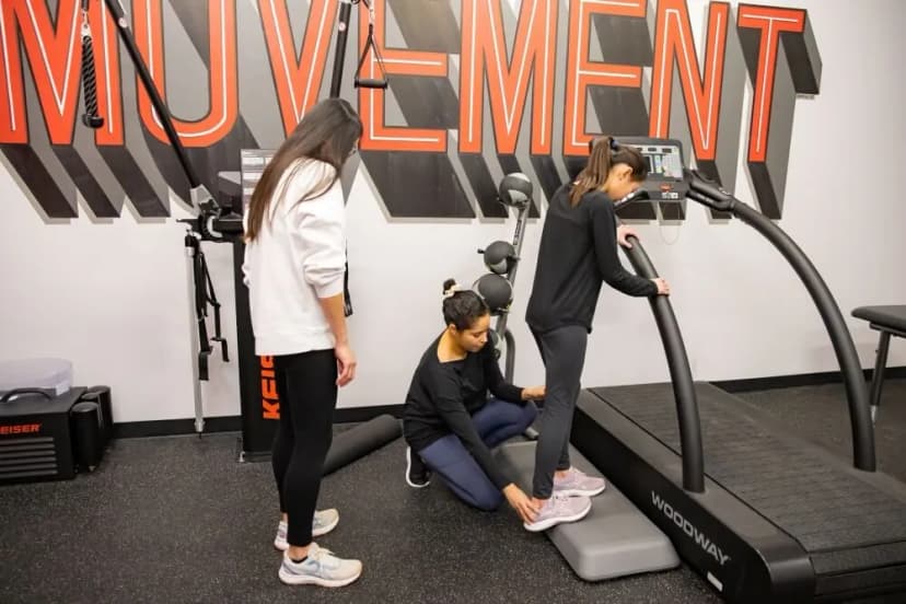 Elysha showing a patient a foot exercise