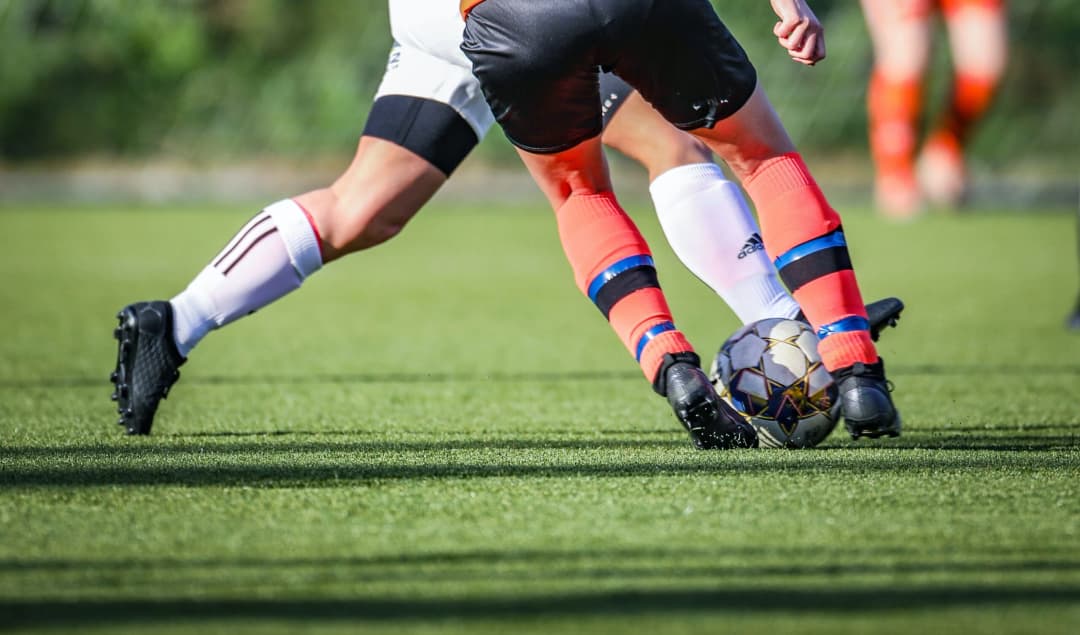 Young women playing soccer on a field